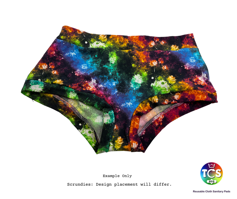 An image of TCS-eco Scrundies with a dark base fabric and rainbow paint splatters.