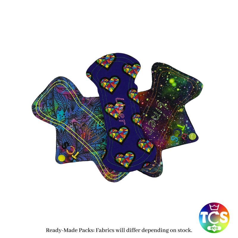 An example Starter pack from TCS-eco.  The Cloth Sanitary Pads with a brightly coloured cotton Jersey top fabric.  The 3 pads are 8” in length and standard width, this starter pack contains 3 different TCS-eco pad shapes.  This shape has a width the same as a disposable sanitary pad.